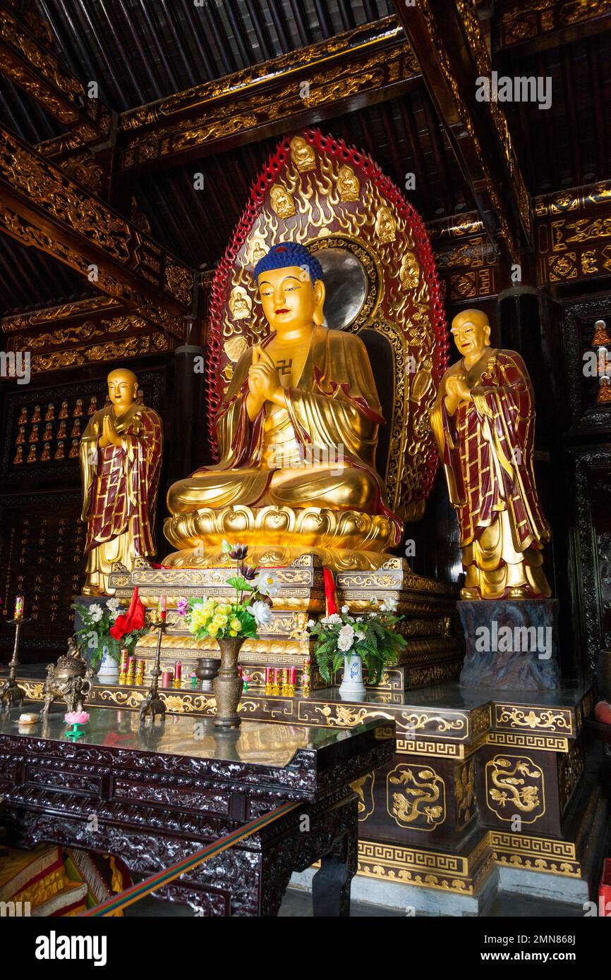 Buddhist shrine with golden Buddha on throne seat in the Hall of Sakyamuni inside the famous Daci'en Temple in the Yanta district of Xi'an. China. PRC. (125) Stock Photo