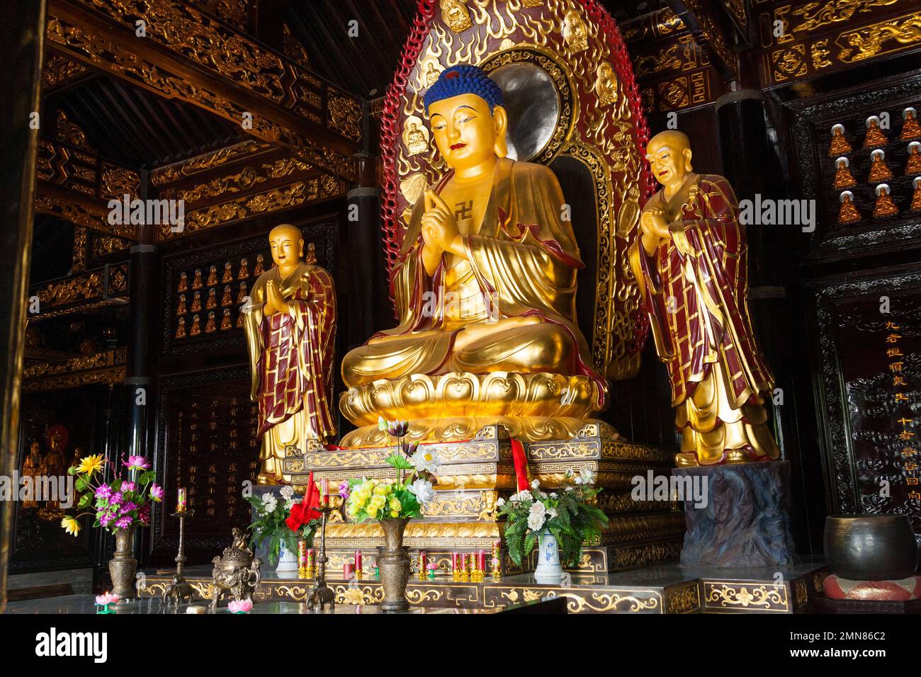 Buddhist shrine with golden Buddha on throne seat in the Hall of Sakyamuni inside the famous Daci'en Temple in the Yanta district of Xi'an. China. PRC. (125) Stock Photo