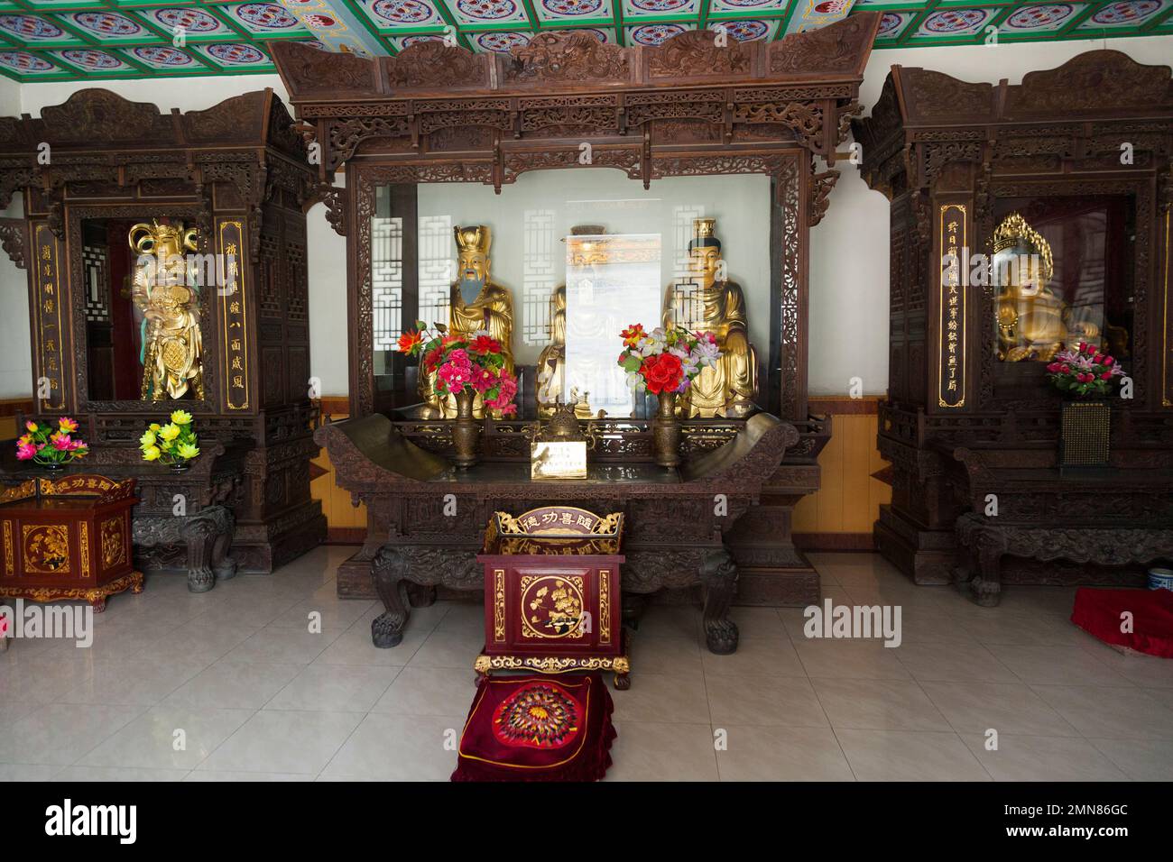 Buddhist figures on display in a glass case, a shrin in the Guardian Hall inside the famous Daci'en Temple in the Yanta district of Xi'an. China. PRC. Stock Photo
