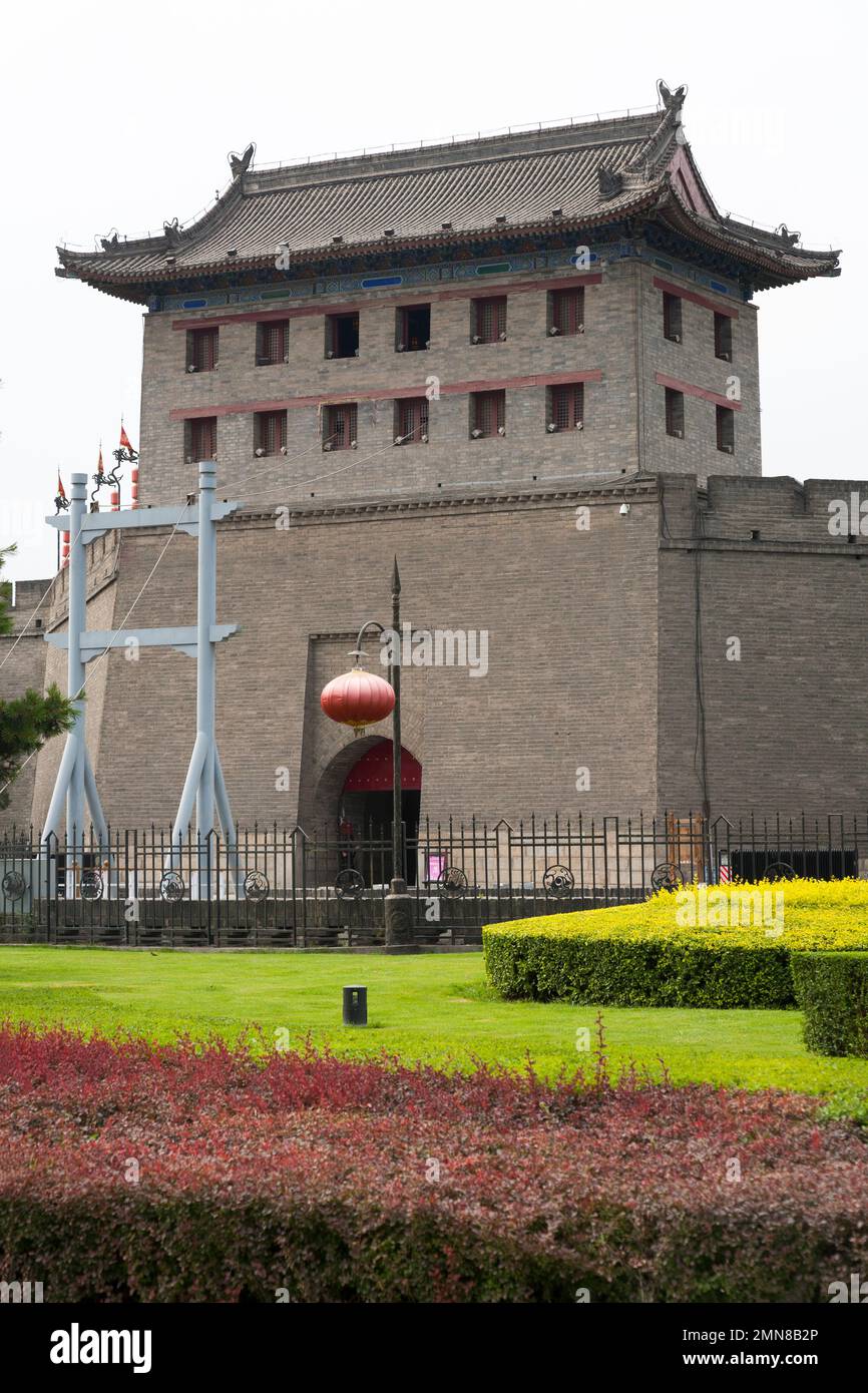 Heavily restored section of the fortifications of Xi'an, also known as Xian City Wall, complete with a gatehouse watch tower, the approach to which is over a lowered drawbridge over water moat. China. PRC. Stock Photo