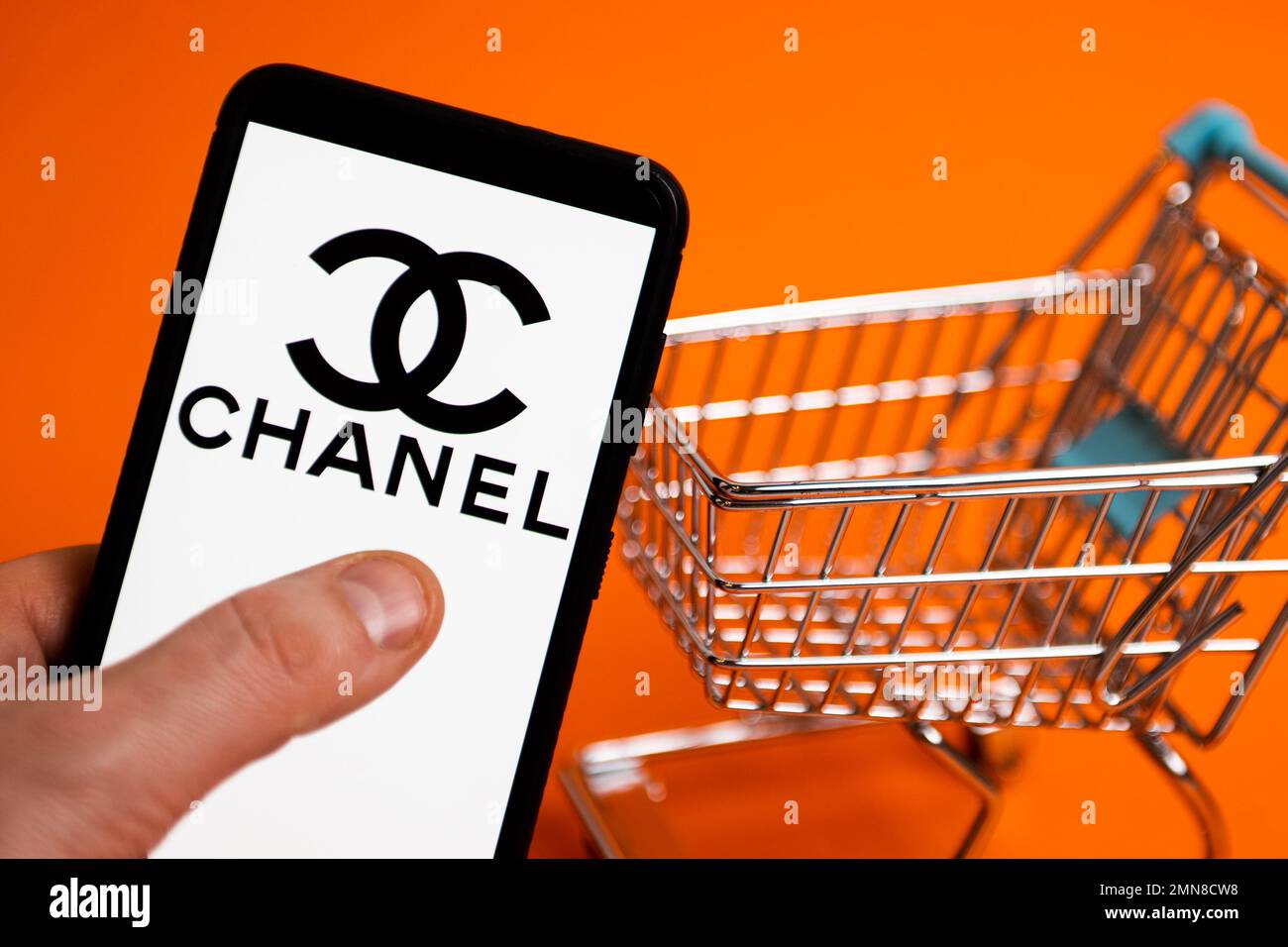 In this photo illustration the French multinational cosmetic beauty brand  Chanel logo seen displayed on a smartphone with USD (United States dollar)  currency in the background. (Photo by Budrul Chukrut / SOPA