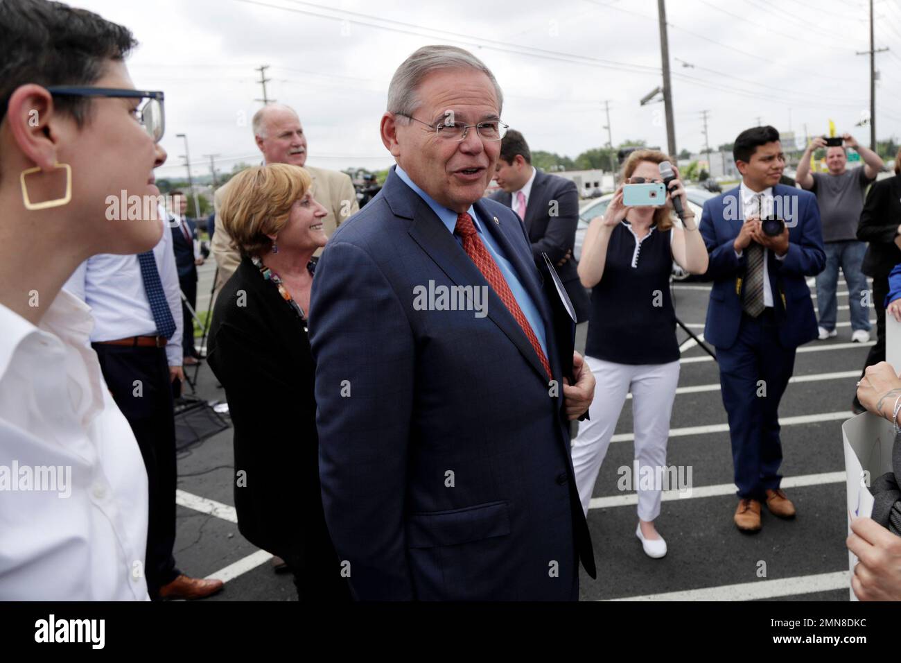 U.S. Sen. Bob Menendez, center, arrives to a news conference talking