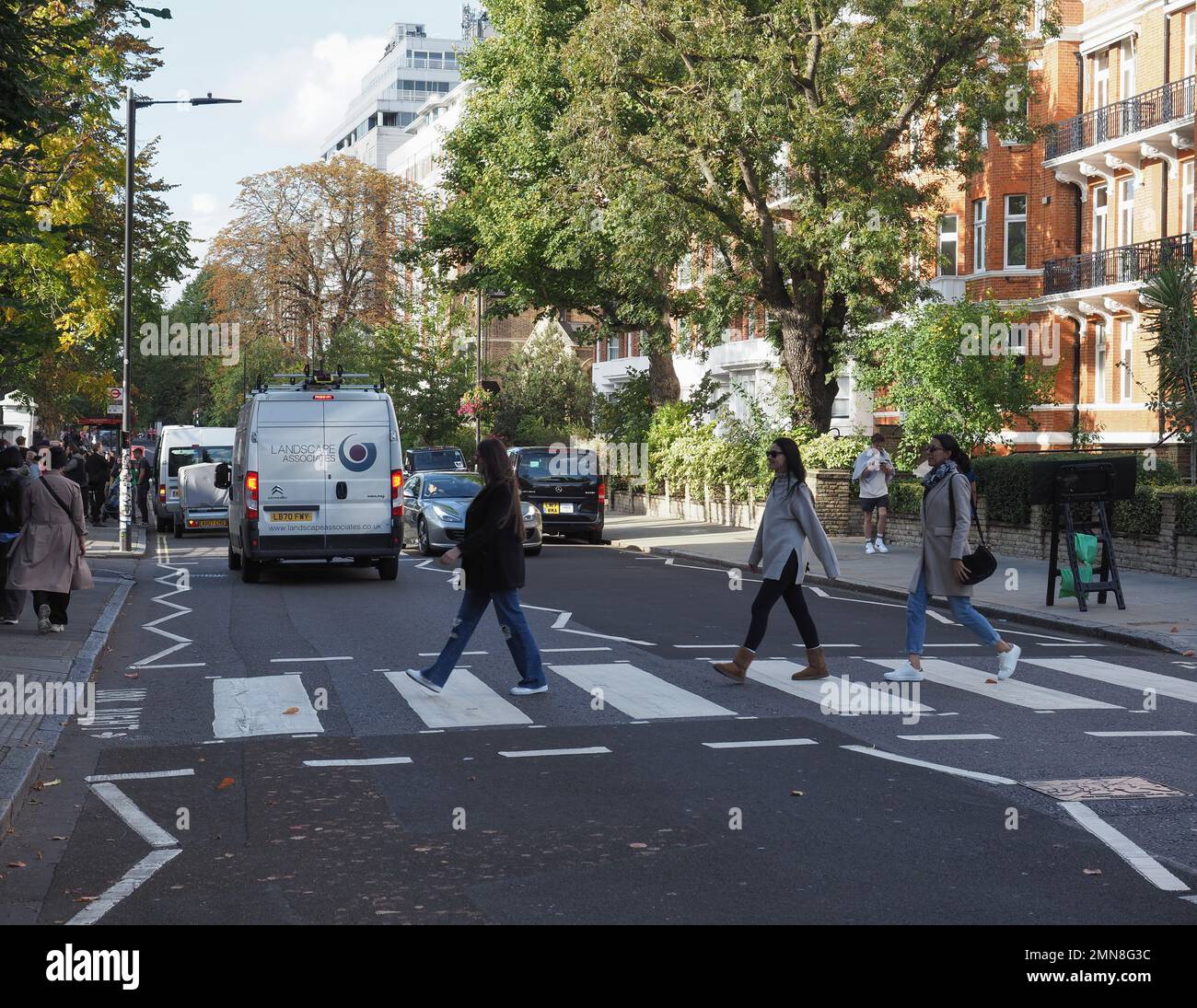LONDON, UK - CIRCA OCTOBER 2022: People crossing Abbey Road zebra