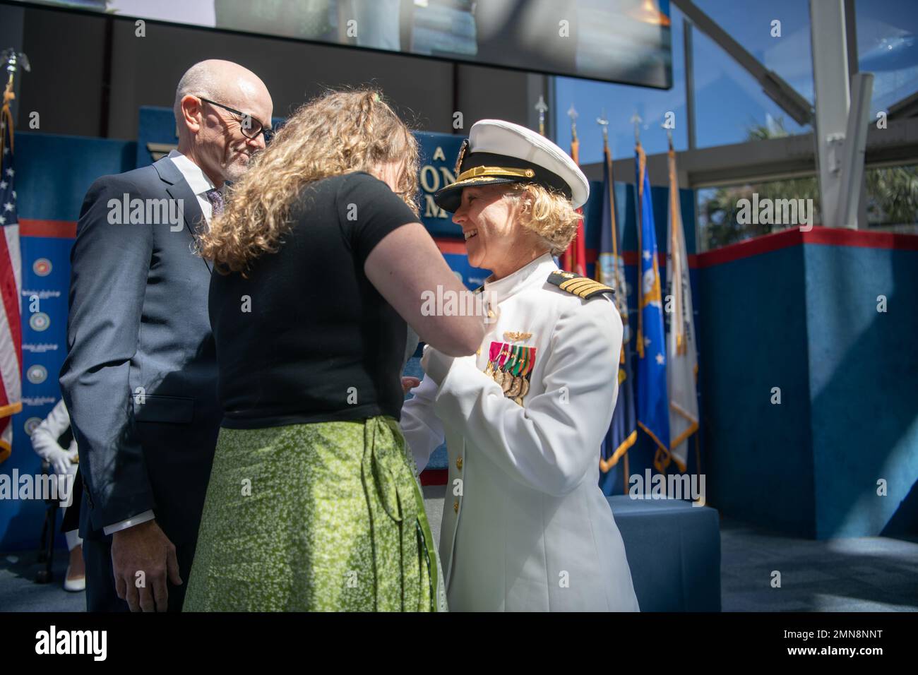 Capt kimberly p toone is pinned by her husband and daughter as she