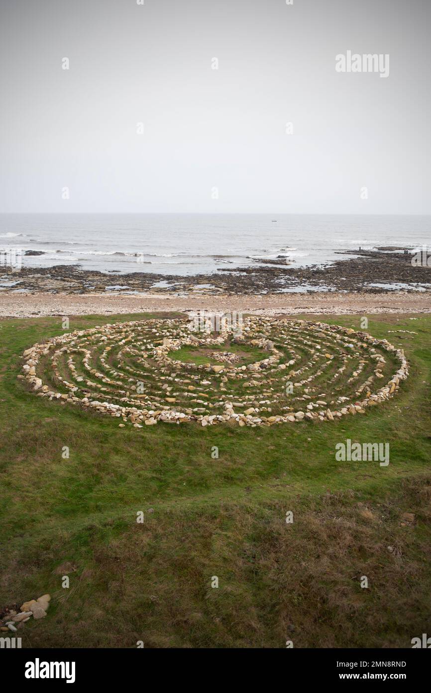 Finn's Labyrinth,set out on grass, a medievel-style puzzle built from stones in 2015 to commemorate the creator's dog in 2015. The Pub Walk in South S Stock Photo