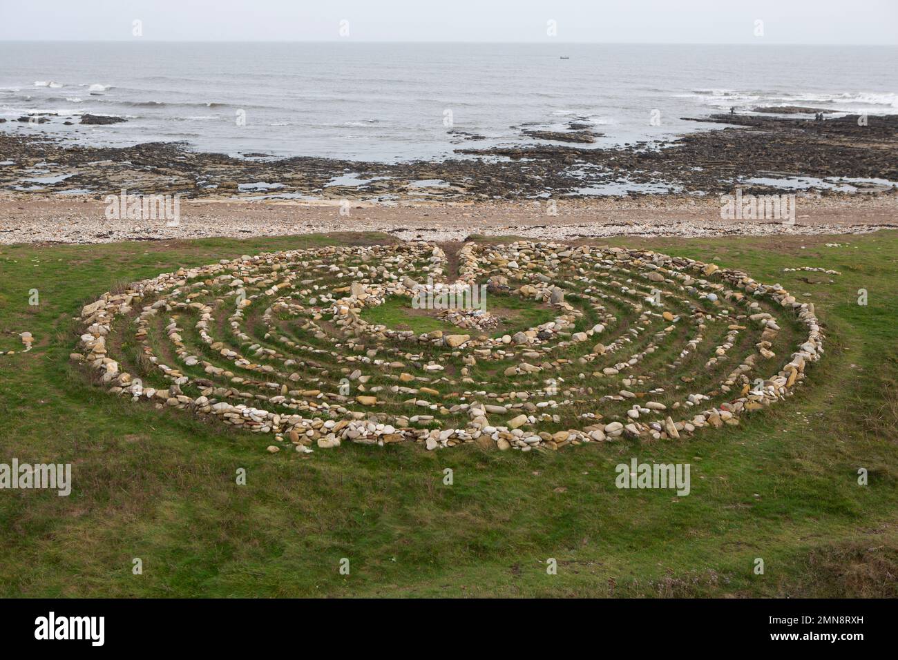 Finn's Labyrinth, set on the beach, a medieval-style puzzle built from stones in 2015 to commemorate the creator's dog. The Pub Walk in South Shields, Stock Photo