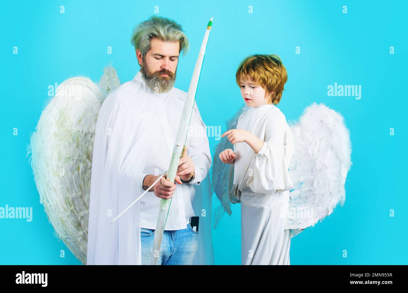 Cupid boy and bearded man with bow and arrow. February 14. Saint Valentines Day. Arrows of love. Stock Photo