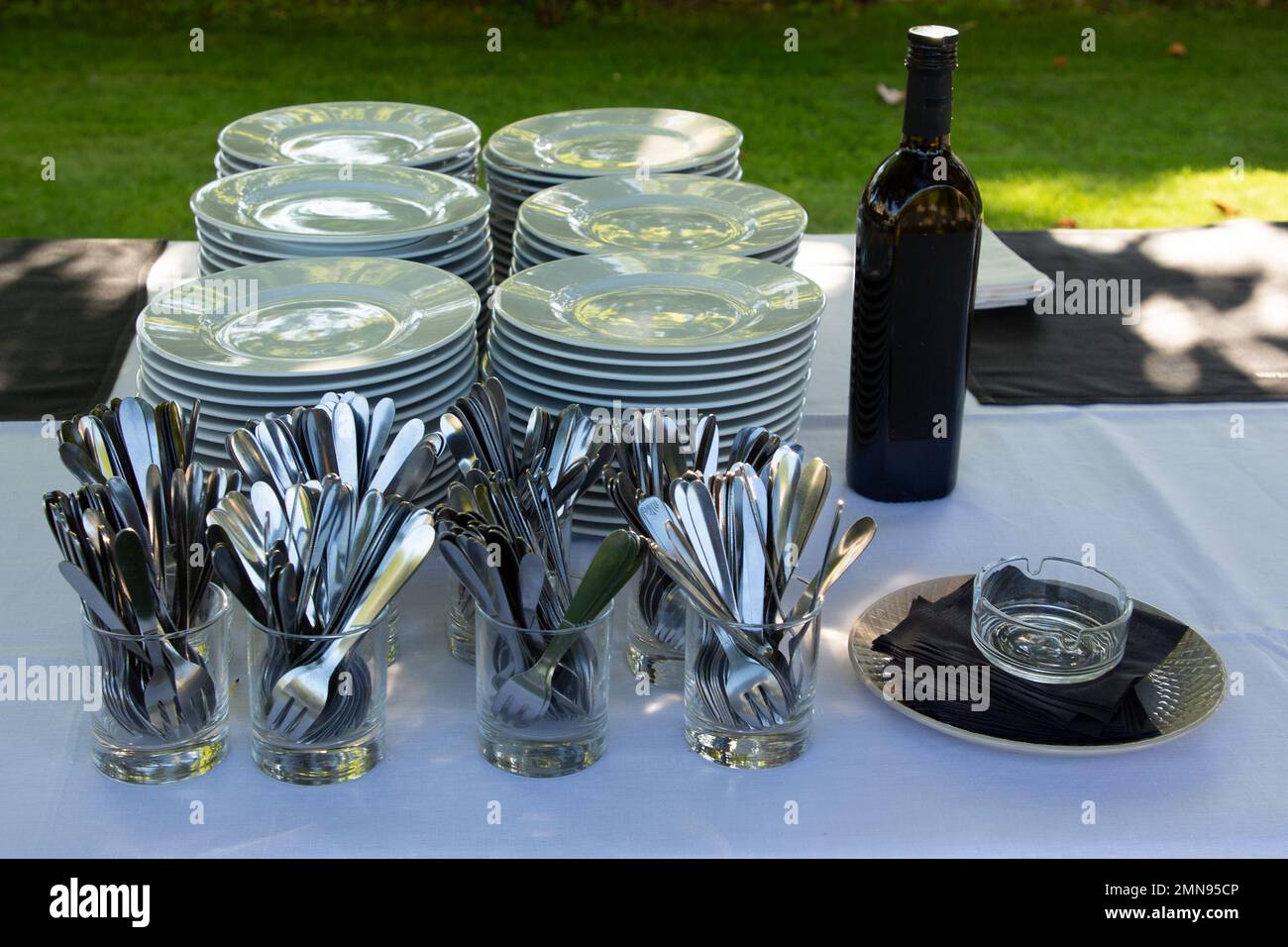 Stack of Cleaned Dishes and cutlery ready to serve in outdoor events