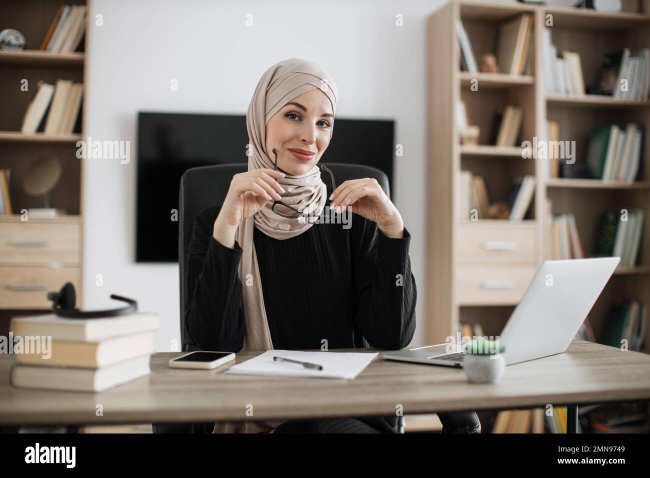 Confident smiling positive muslim woman in formal wear and hijab ...