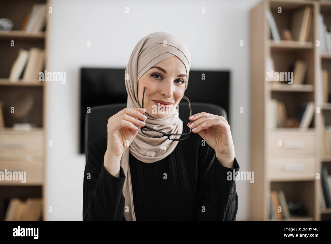 Confident smiling positive muslim woman in formal wear and hijab ...