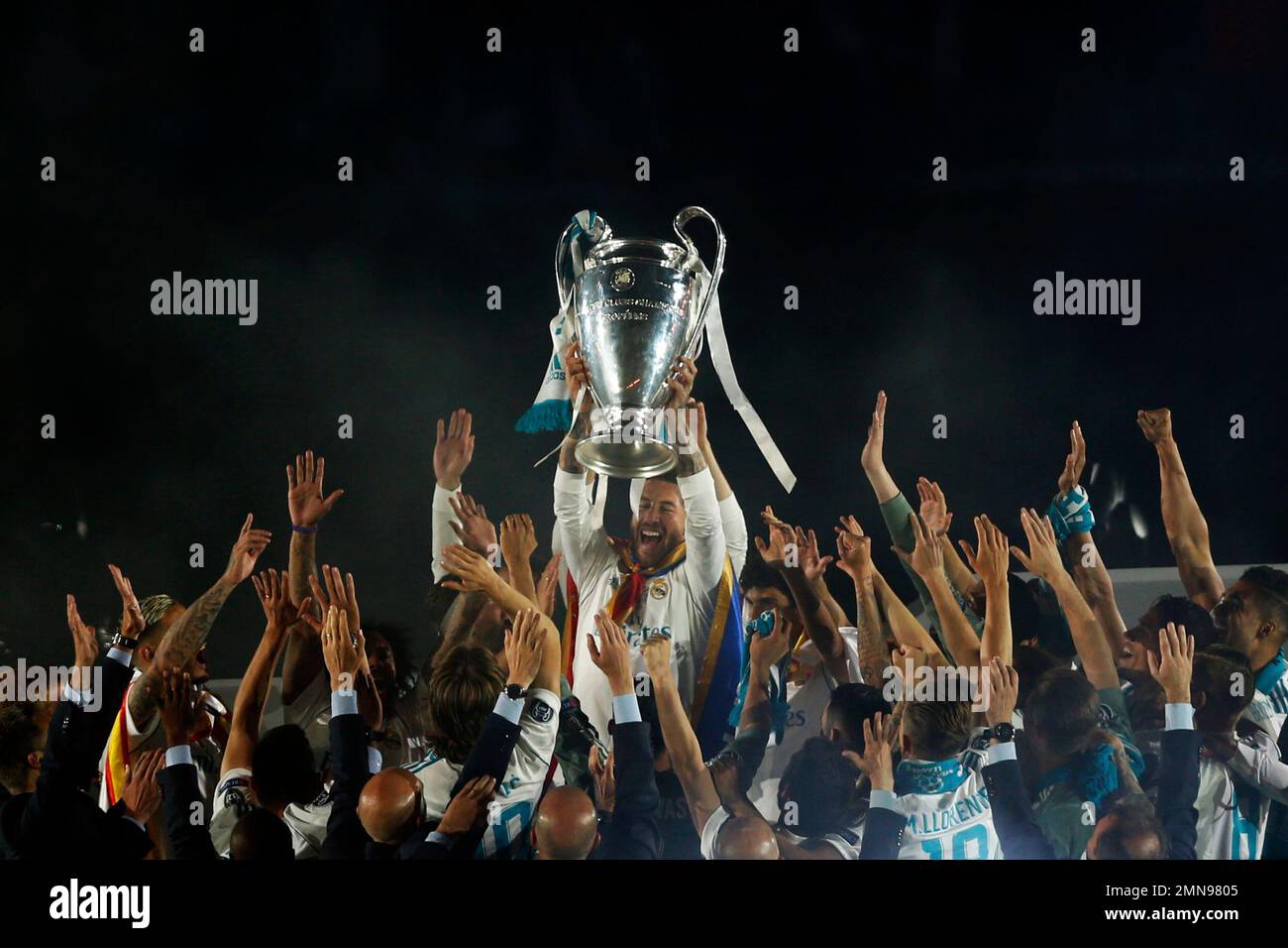 Real Madrid players celebrate with their trophy after winning the ...