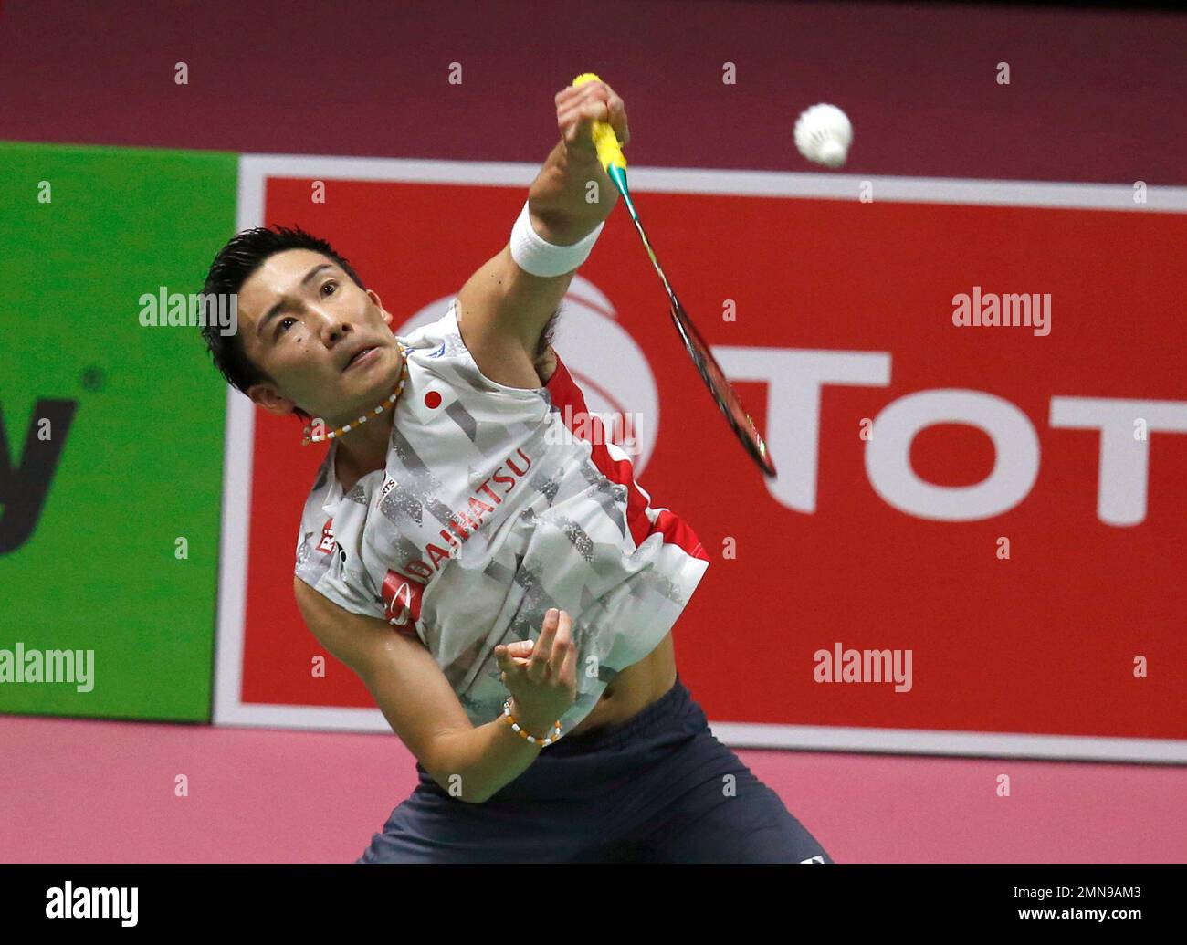 Kento Momota of Japan returns a shot to Jonatan Christie of Indonesia in their eighth-final match of mens singles during the YONEX-SUNRISE Hong Kong Stock Photo