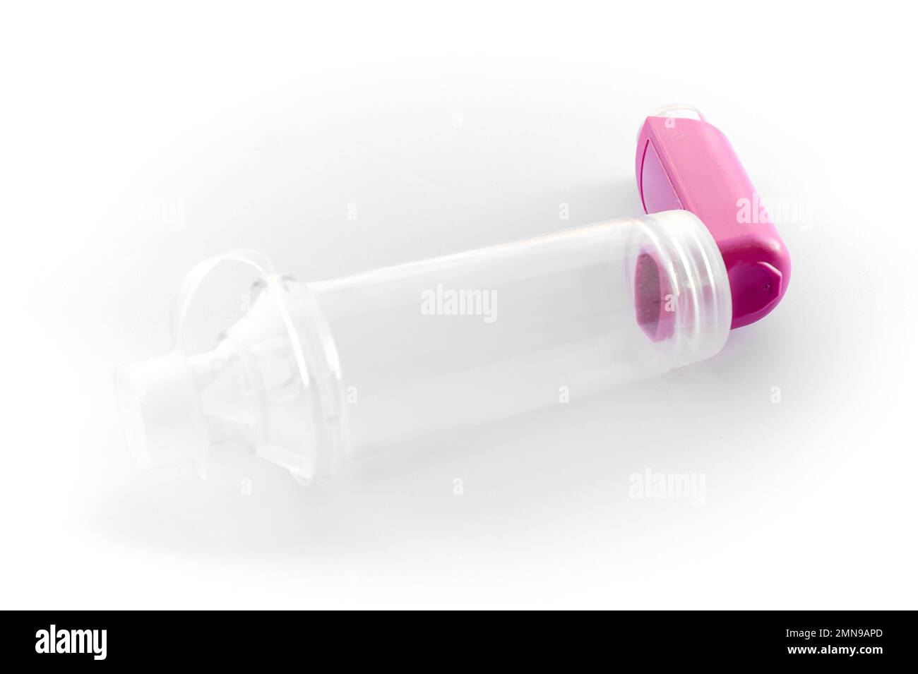 Lung medication with corticosteroids for asthma or COPD. An inhaler with spacer with white background. Stock Photo