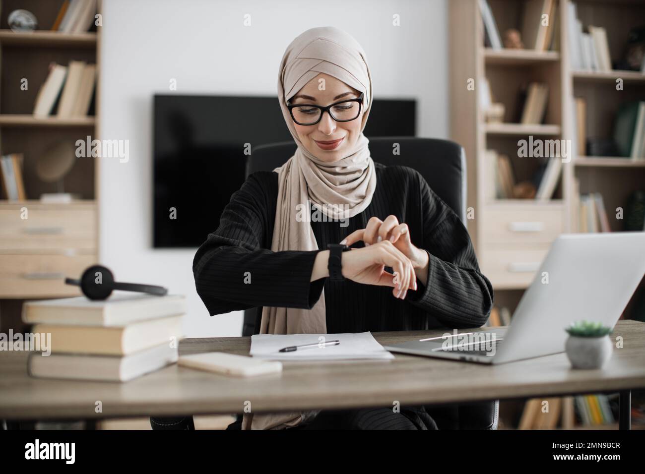 Young smiling happy successful employee muslim business woman in hijab ...