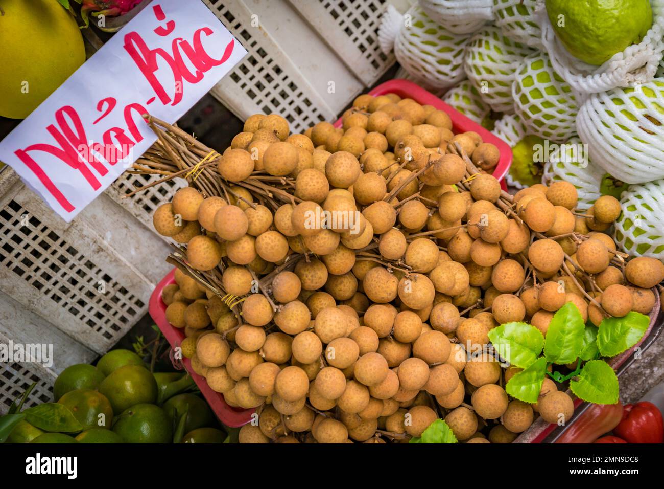 Longan fruit at a market stand in Vietnam. Stock Photo
