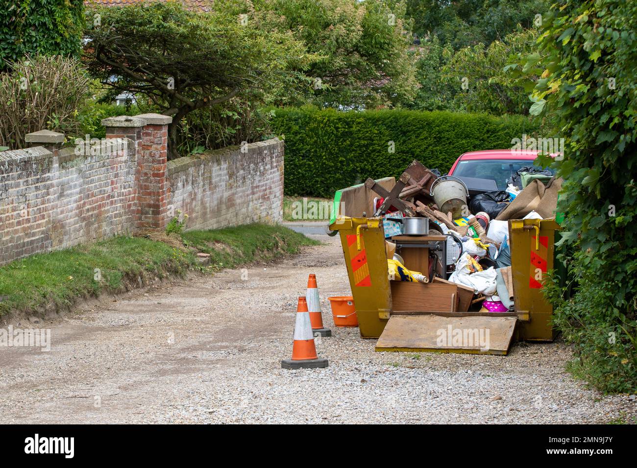 Open Skip A house clearance uses an open skip revealing the unwanted remains of a ...
