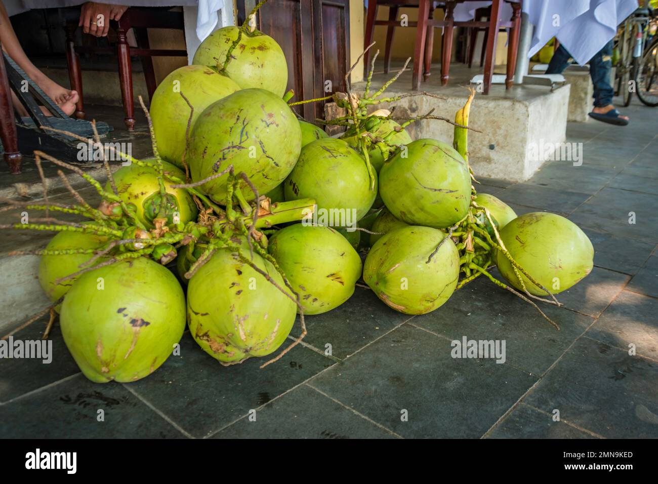 Pile of fresh coconuts lying on the ground at a market Stock Photo Alamy