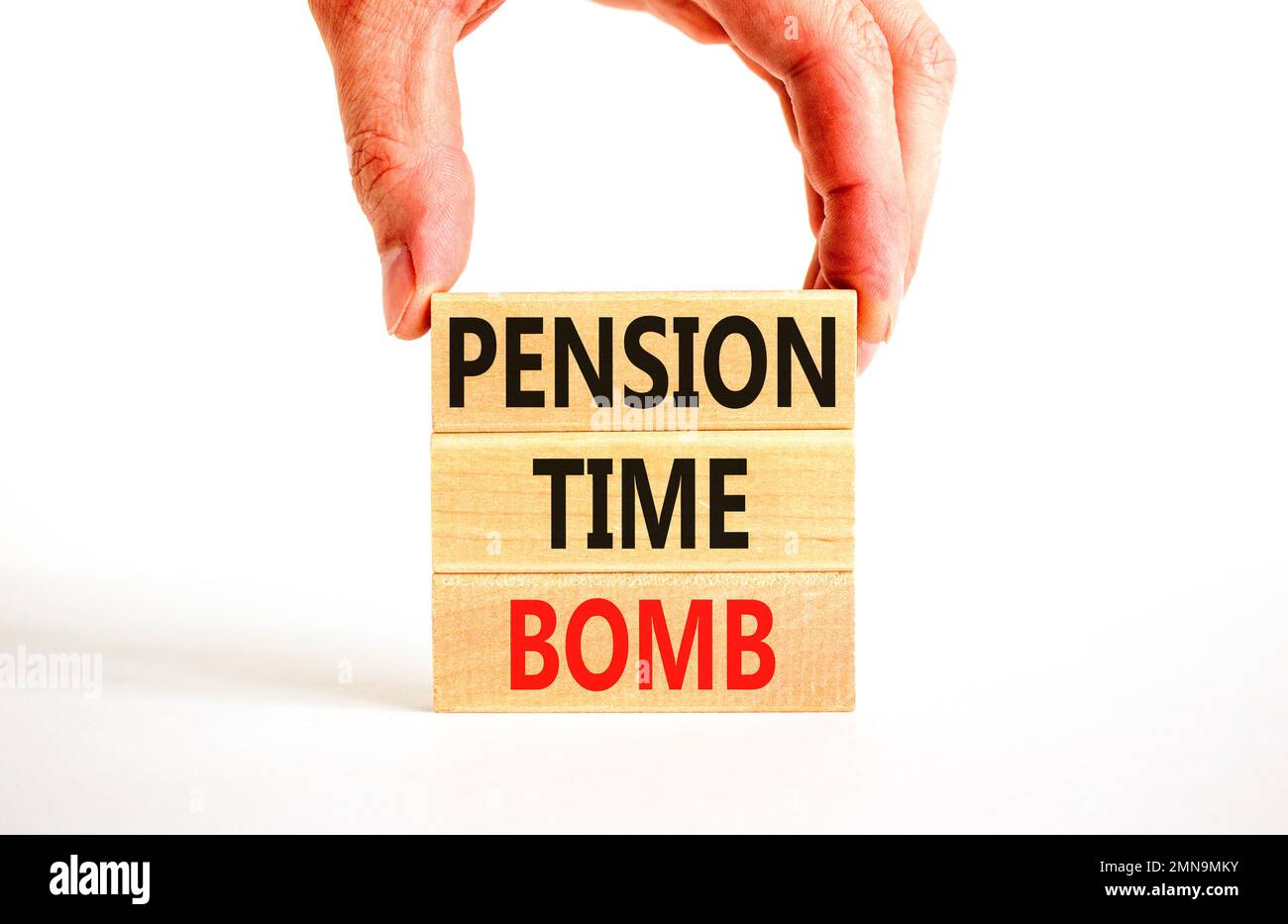 Pension time bomb symbol. Concept words Pension time bomb on wooden blocks on a beautiful white table white background. Businessman hand. Business pen Stock Photo