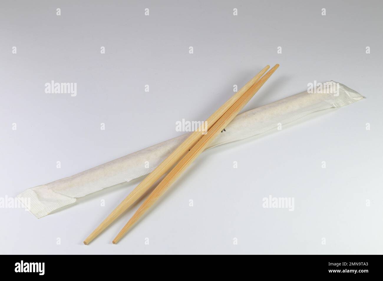 ready-made or disposable Brown bamboo chopsticks with package isolated on white background. Stock Photo