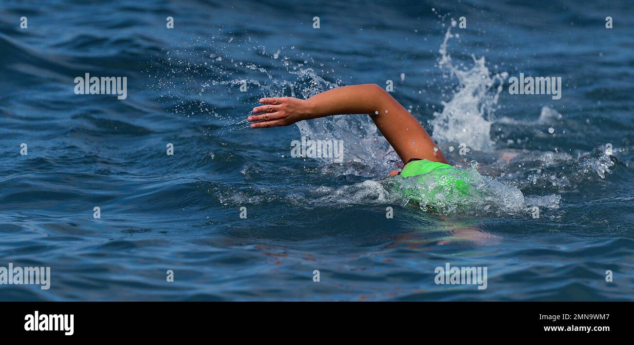 Arm of a swimmer athlete swimming in the ocean, competition swimming at