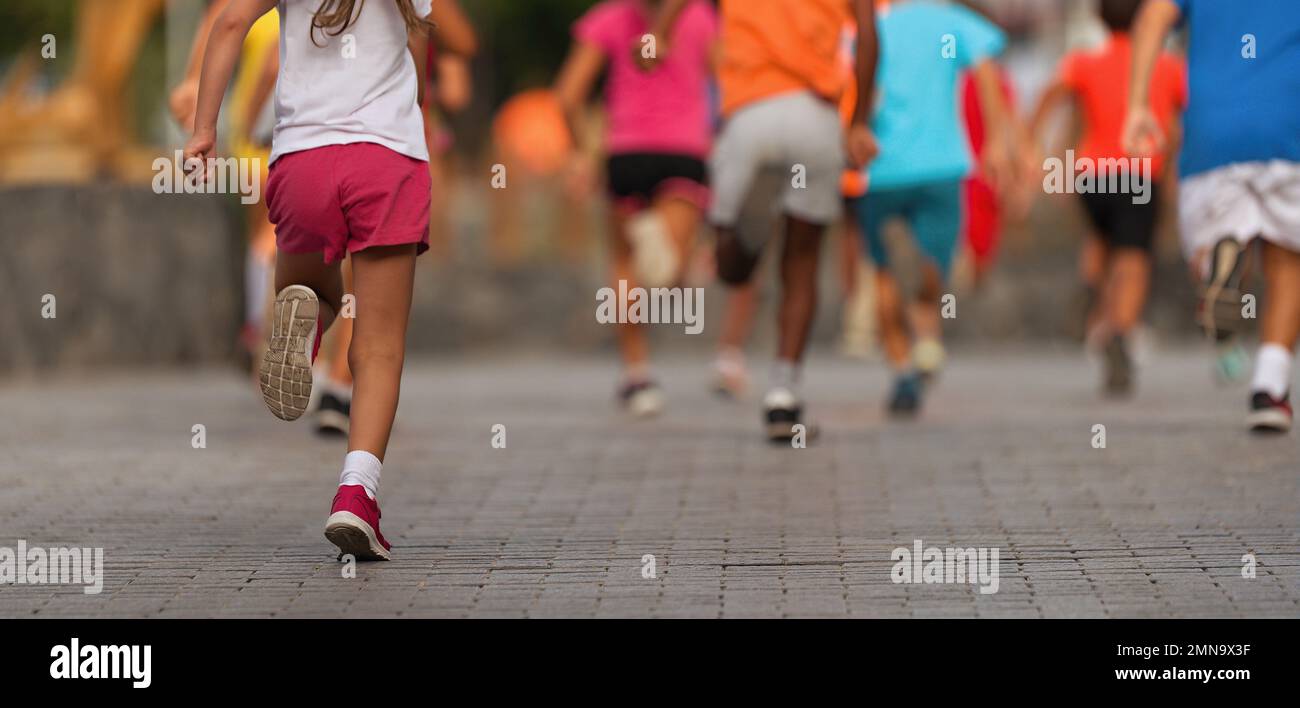Running children, young athletes run in a kids run race,running on city