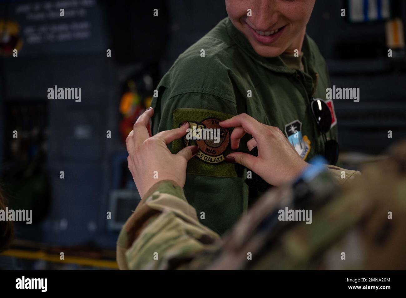 Staff Sgt. Amelia Bradfield, 9th Airlift Squadron loadmaster, puts a ...