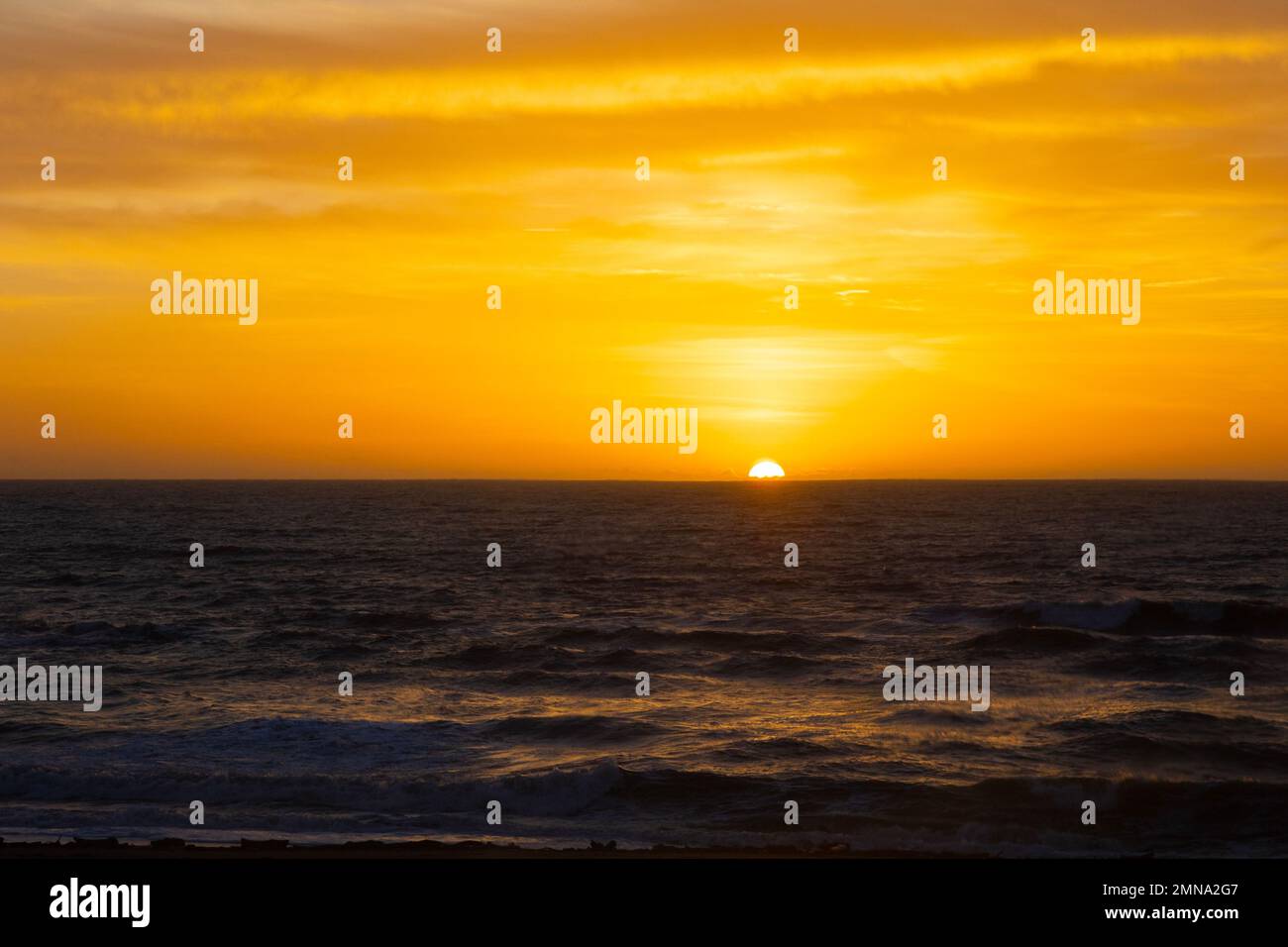 Sun Setting over Pacific Ocean Stock Photo