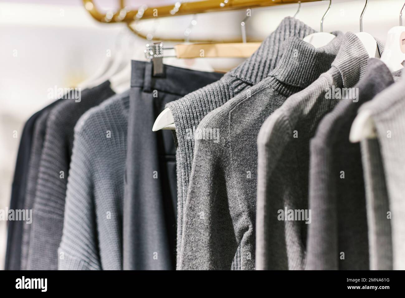 Background image of Autumn knitwear collection in grey tones on rack in clothing boutique, copy space Stock Photo
