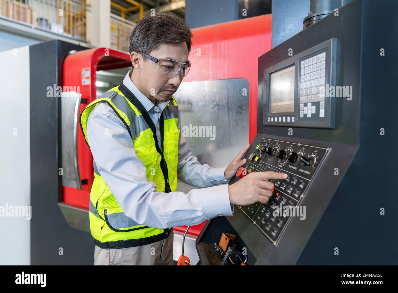 Engineers wear protective overalls working in the factory Stock Photo