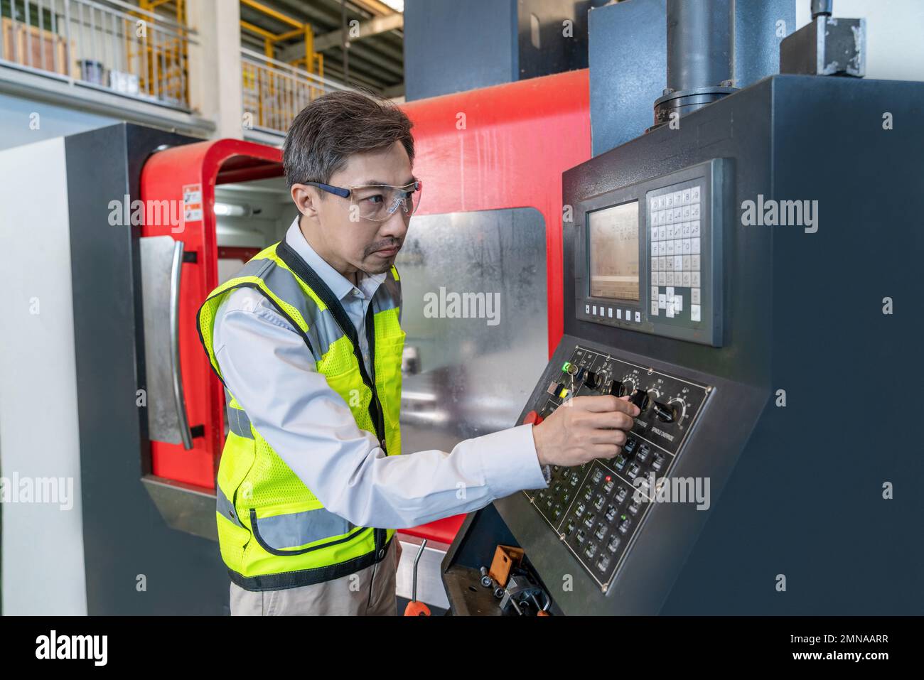 Engineers wear protective overalls working in the factory Stock Photo