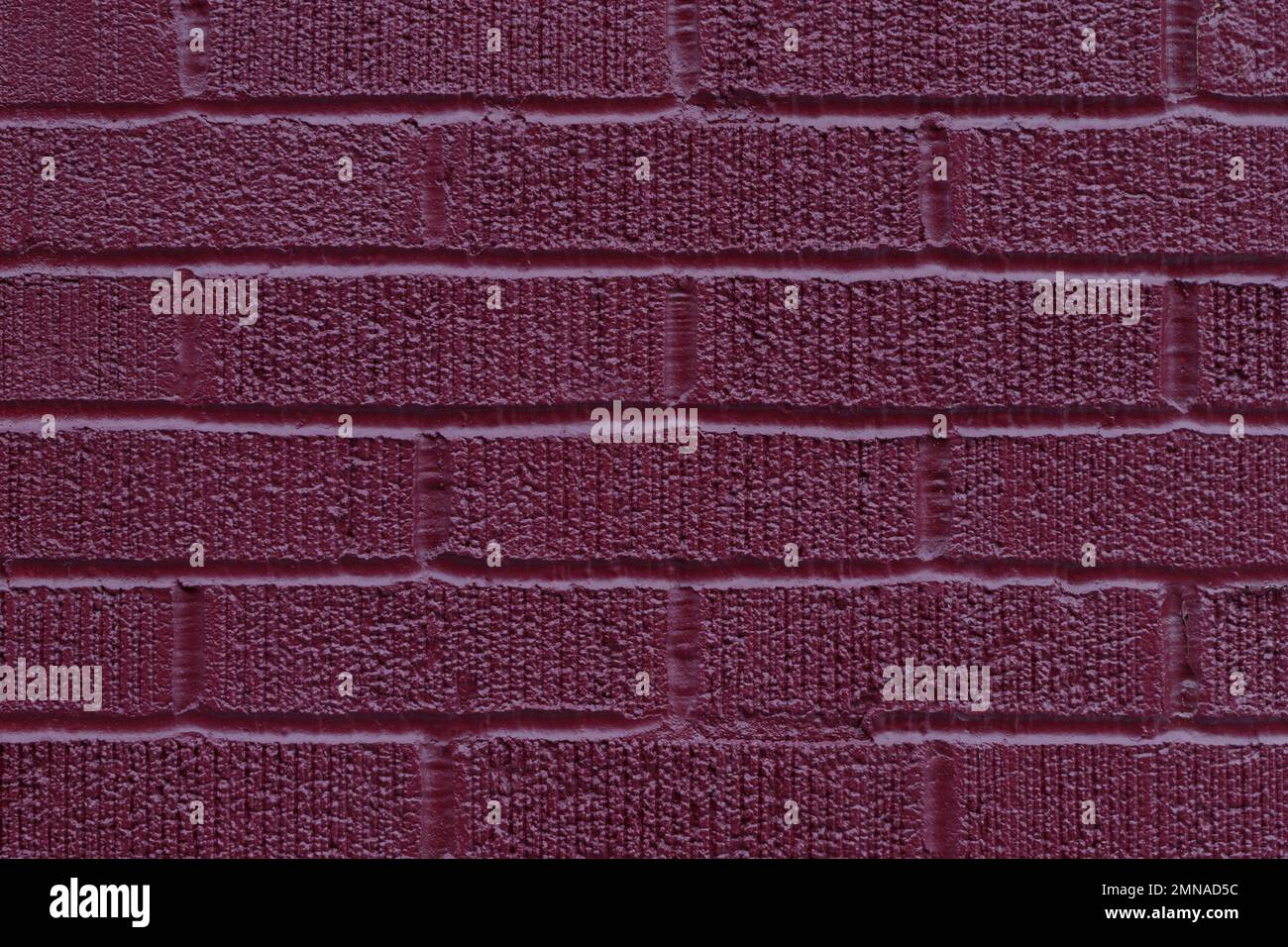 Painted dark pink brick wall texture vertical background Stock Photo