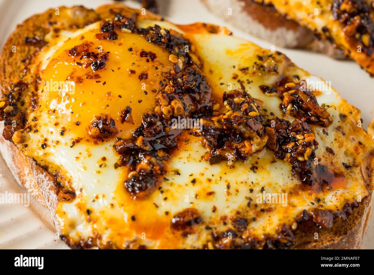 Trendy Homemade Chili Crunch Eggs with Toast Stock Photo