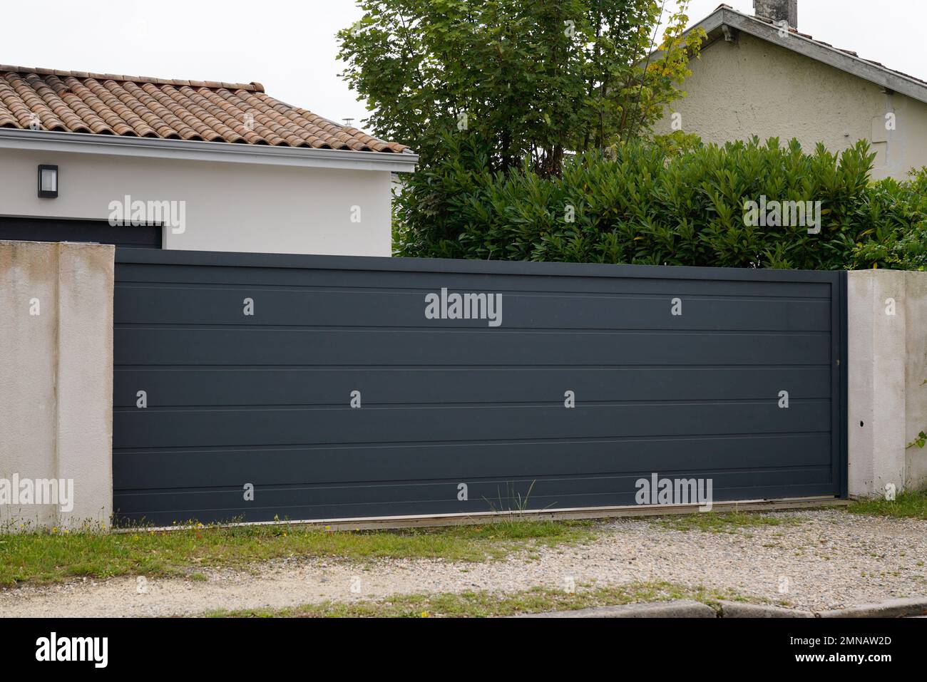 grey dark slide home steel door sliding aluminum gate slats Stock Photo