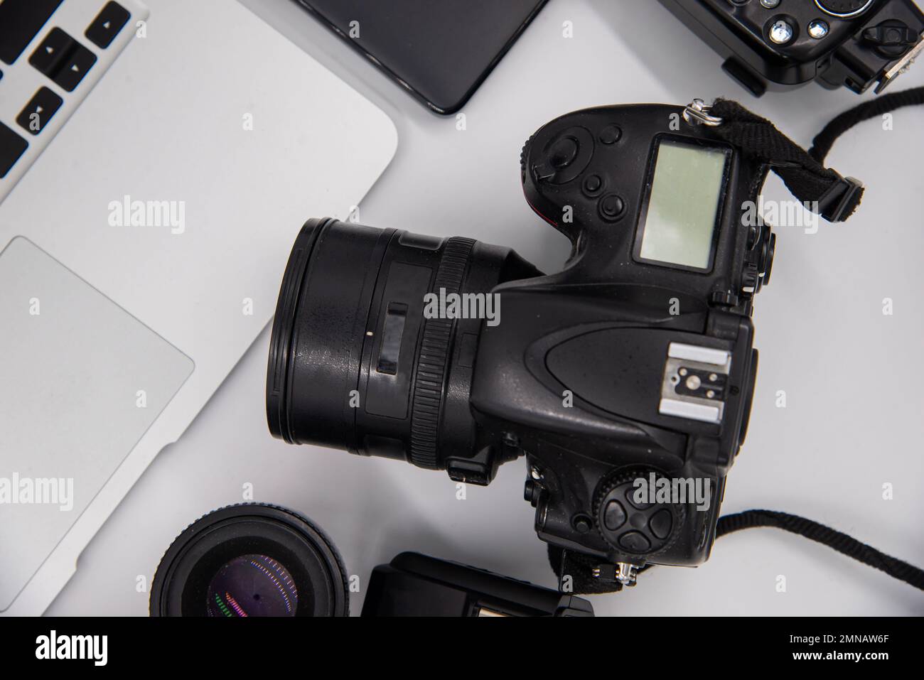 top view of work space photographer with digital camera, flash ...