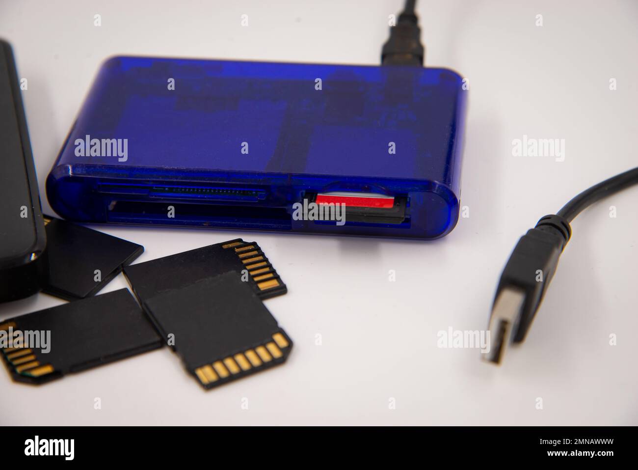 Black memory cards and external hard drive with blue card reader and