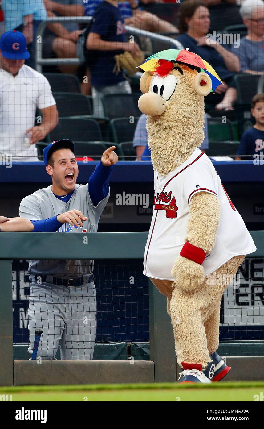 Chicago Cubs center fielder Albert Almora Jr. (5) jokes with Atlanta Braves mascot Blooper before a baseball game Thursday, May 17, 2018, in Atlanta. (AP Photo/John Bazemore) Stock Photo