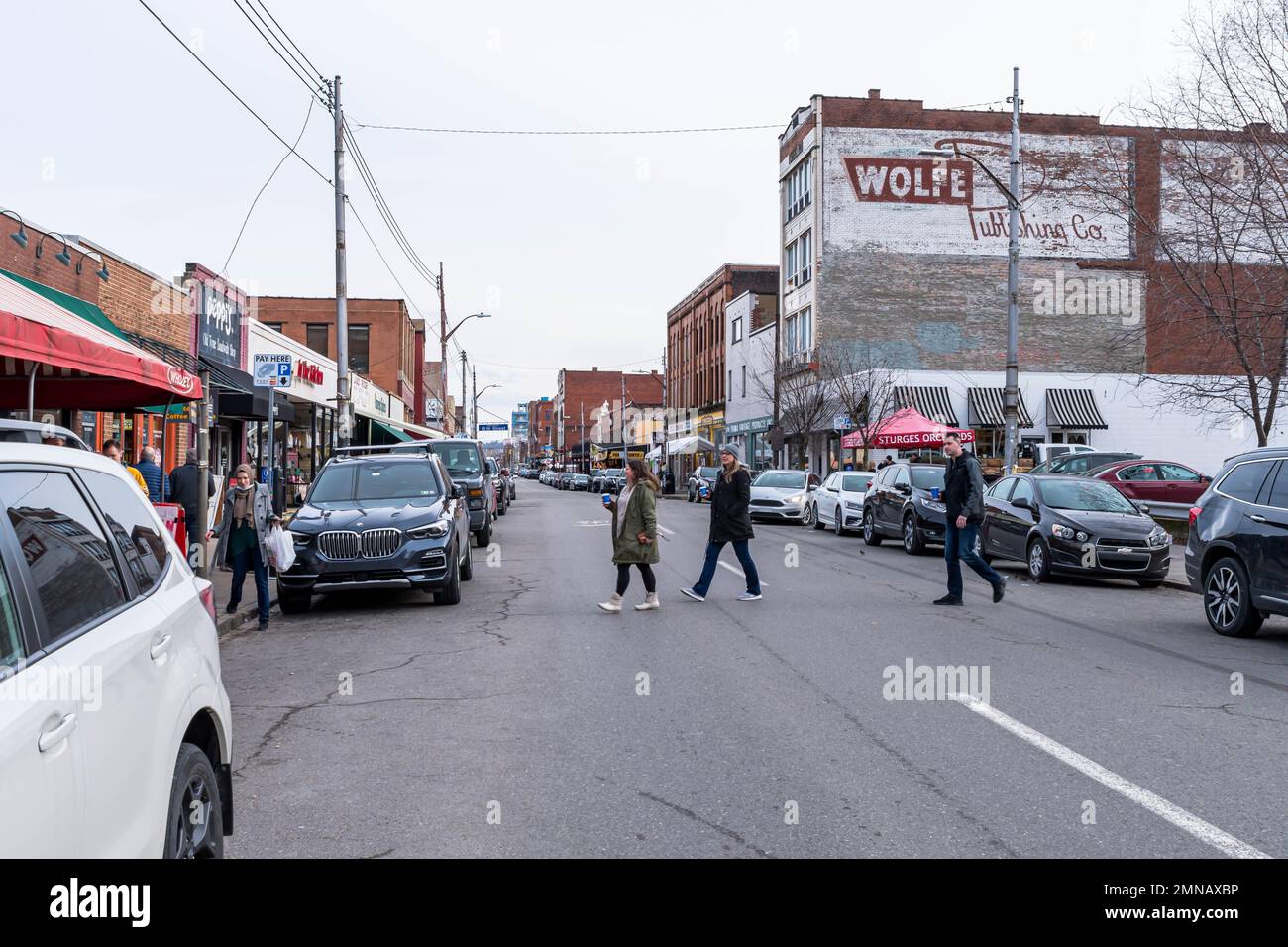 People crossing Penn Avenue in the Strip District neighborhood in ...