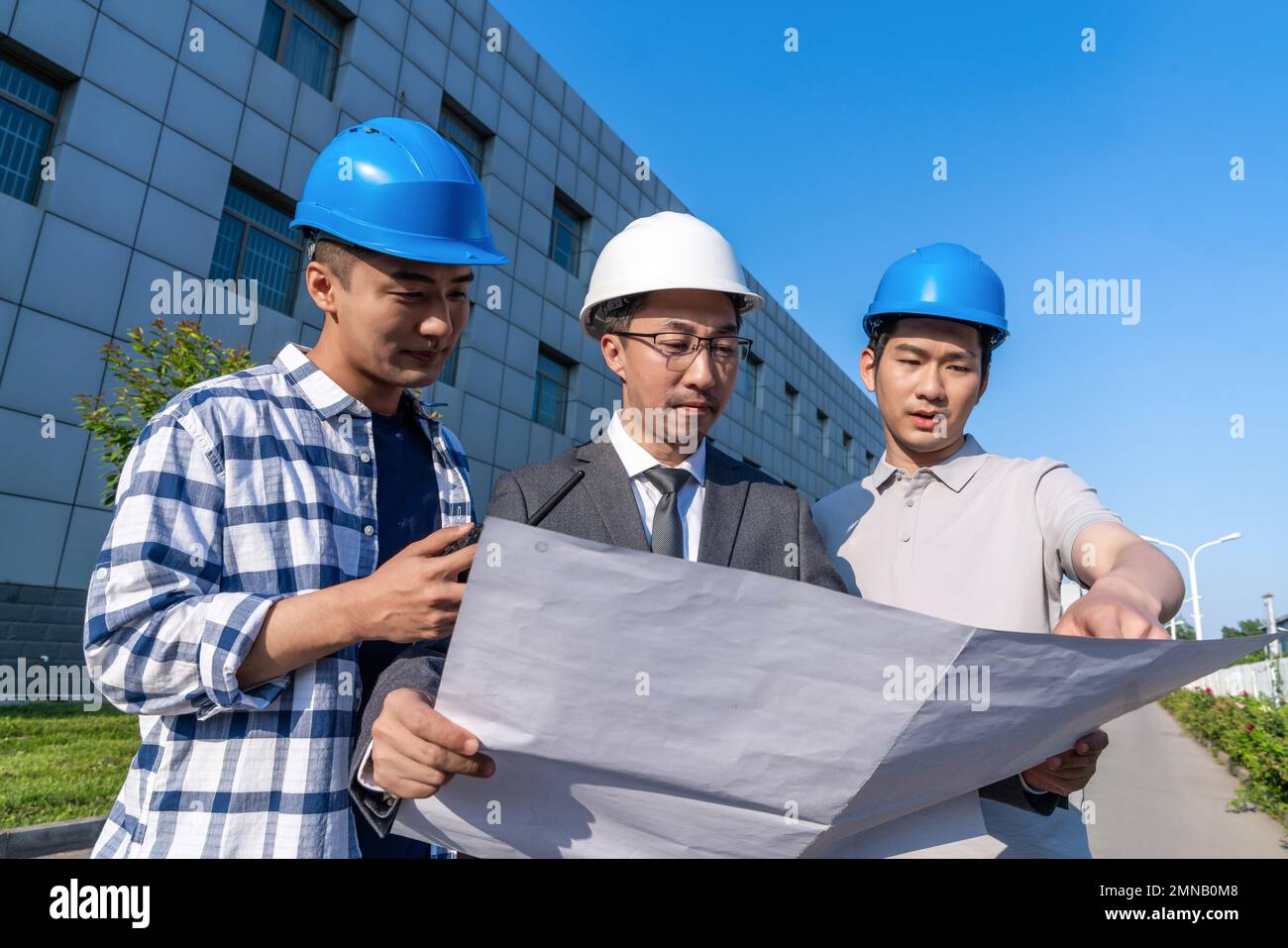 Three engineers working in the outdoor Stock Photo Alamy