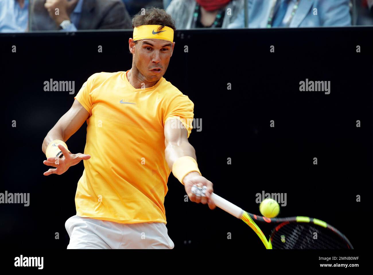 Spains Rafael Nadal returns the ball to Canadas Denis Shapovalov, at the Italian Open tennis tournament in Rome, Thursday, May 17, 2018 (AP Photo/Alessandra Tarantino Stock Photo
