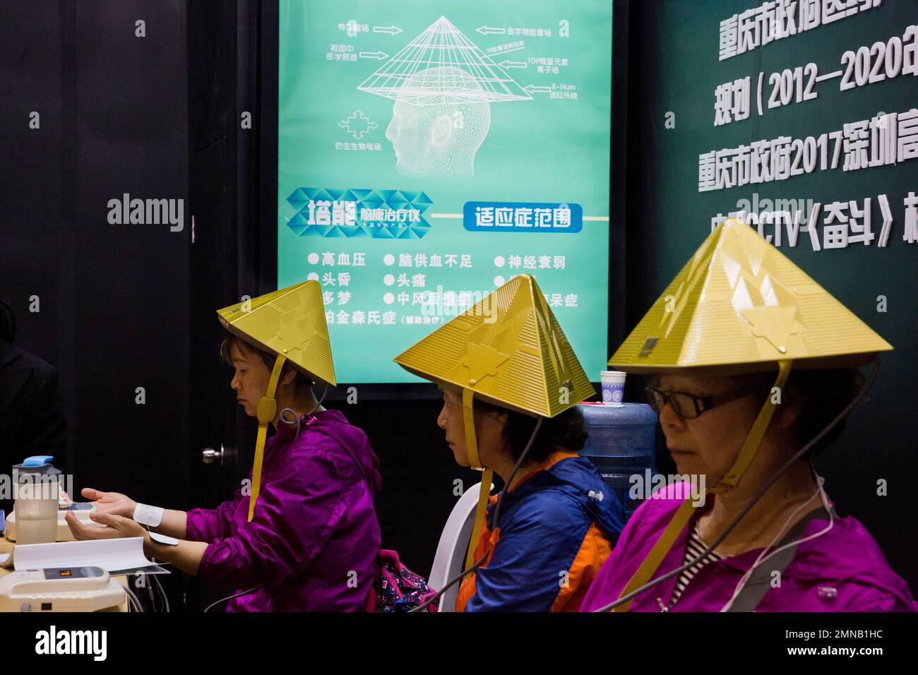 Chinese women try out a pyramid-shaped device purported to improve ...