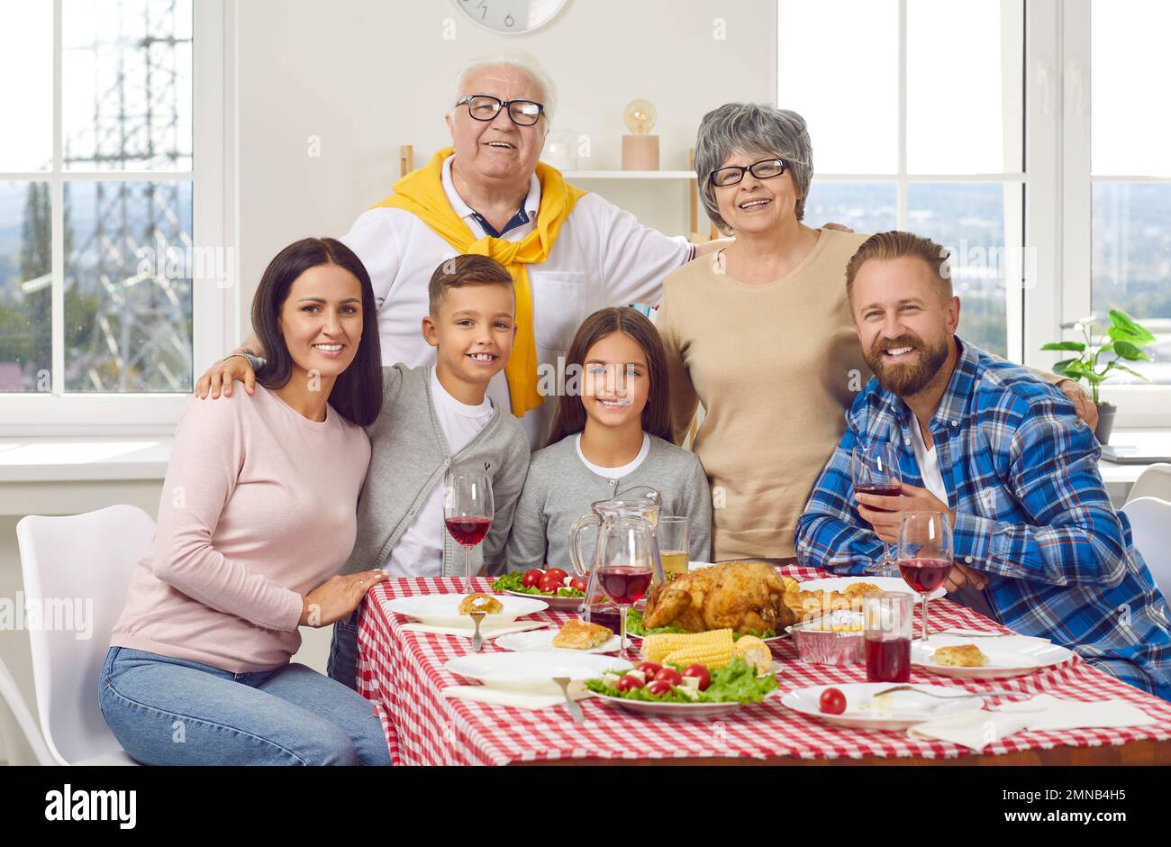 Portrait of happy family of three generations who celebrate Thanksgiving together. Stock Photo