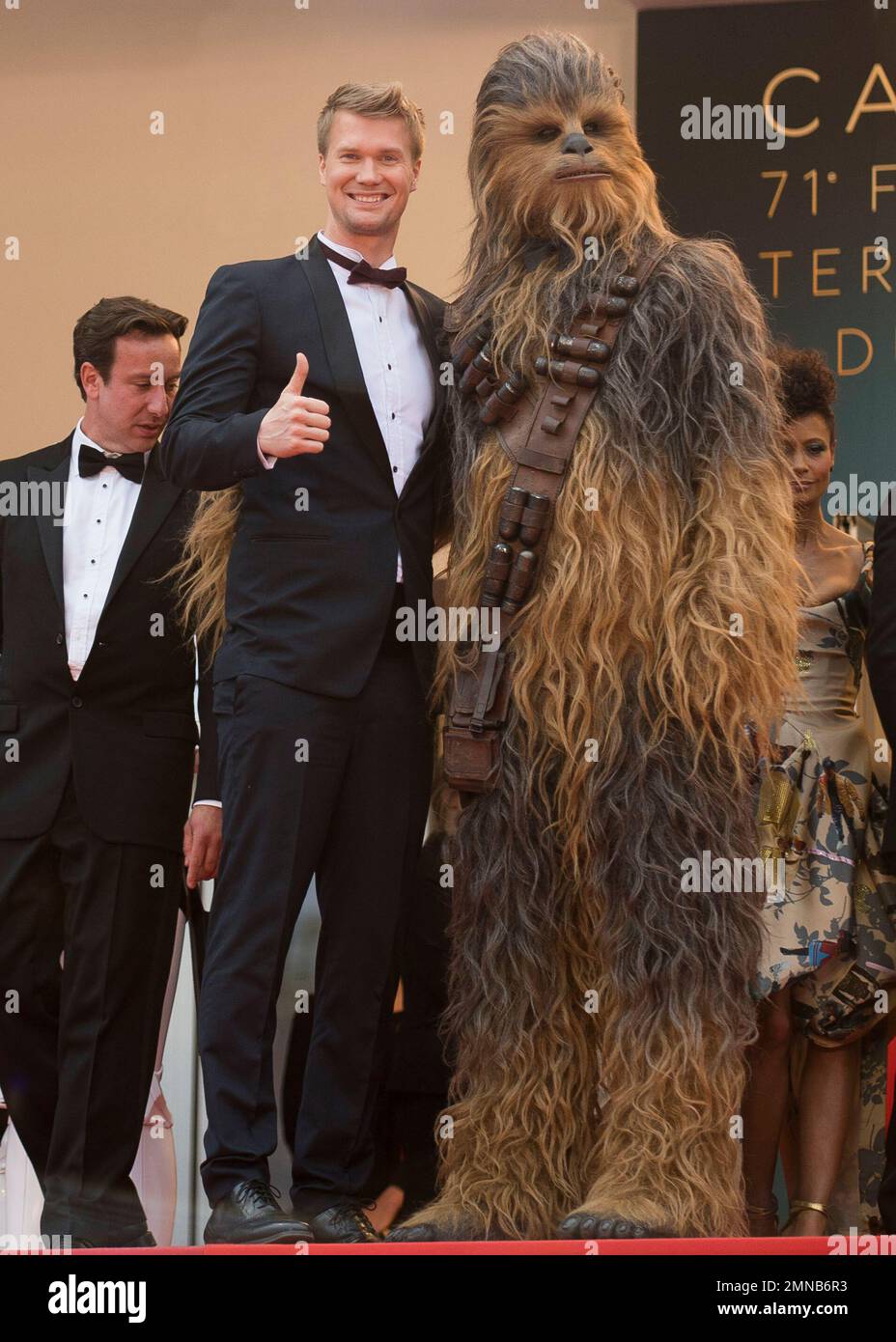 Actor Joonas Suotamo poses with a person wearing a costume of the