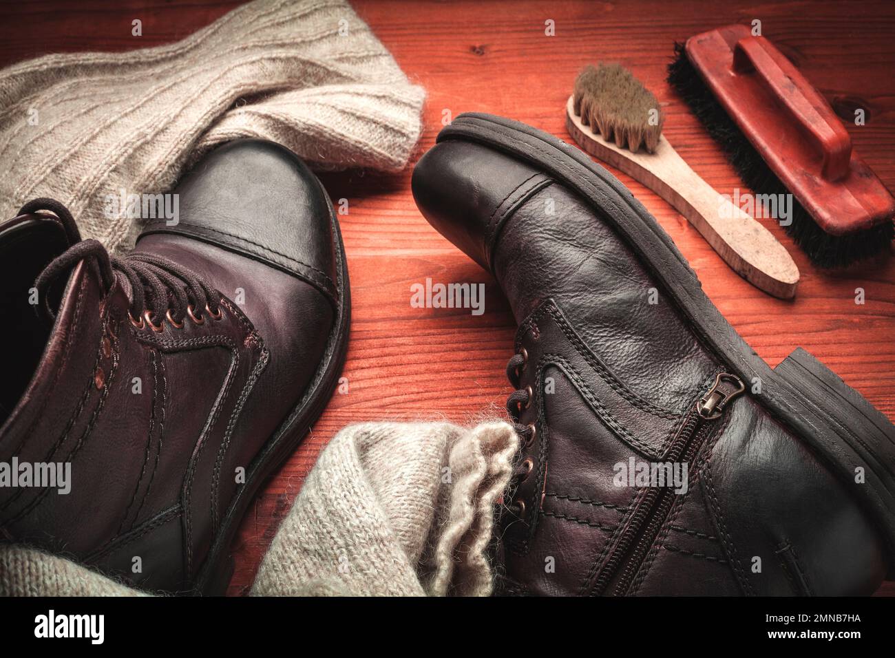 Concept of care and cleaning of vintage leather boots with wax, cream, sponge and brush Stock Photo