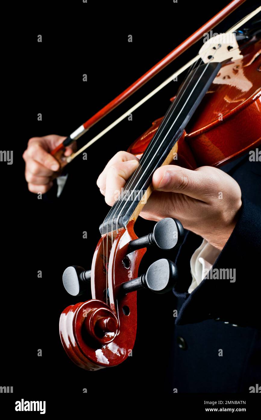 Detail of the violinist's hands, playing the notes of the violin with a