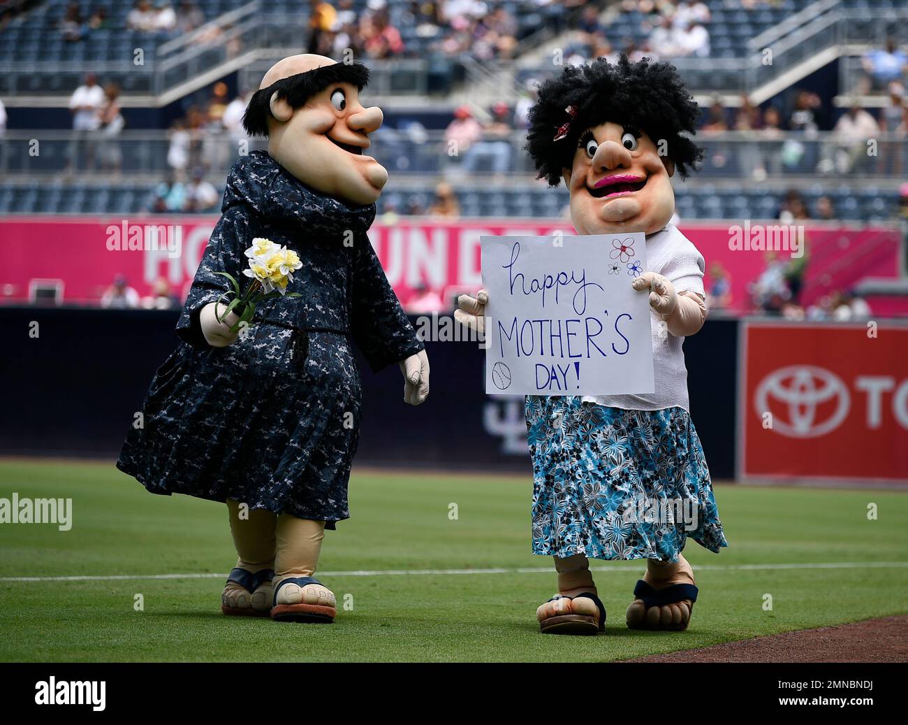 San Diego Padres mascot The Swinging Friar, left, walks on the field with  another mascot dressed as the Friar's mother to celebrate Mother's Day  prior to a baseball game against the St., image size:1300x1037