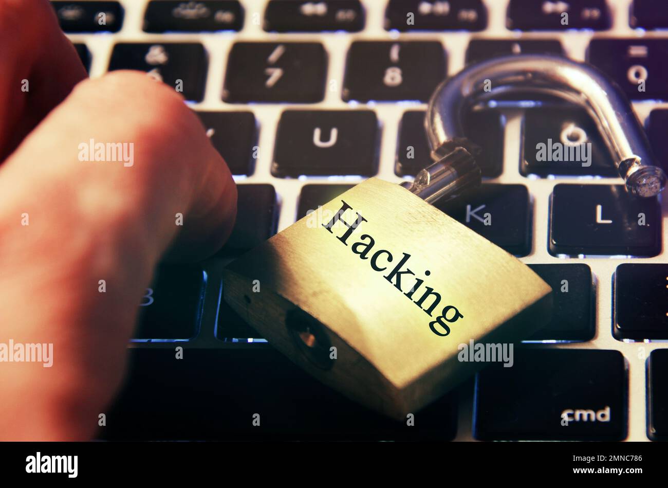 Hacked symbol on computer keyboard with open padlock Stock Photo