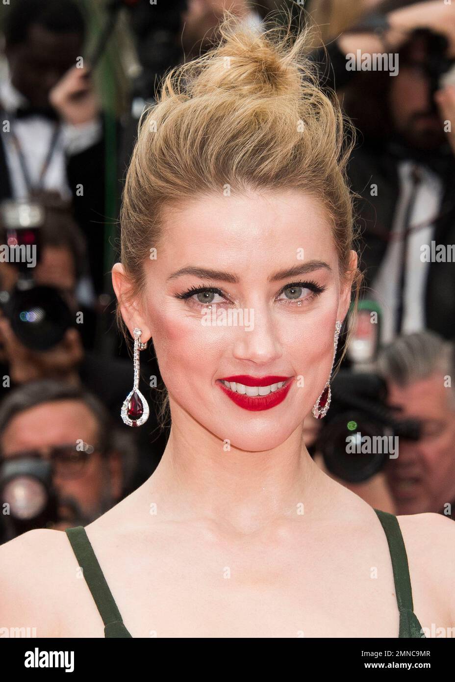 Actress Amber Heard poses for photographers upon arrival at the