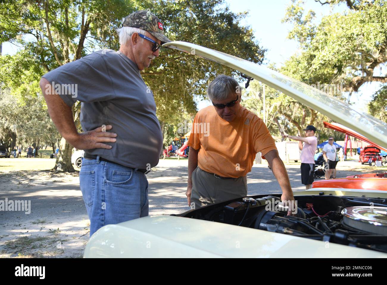 U.S. Army Retired Master Sgt. Melvin Gregory and Roger Ewing inspect an antique vehicle during the 19th Annual Cruisin' Keesler Car Show and Parade at the Marina Park at Keesler Air Force Base, Mississippi, October 1, 2022. The event is held to kick off Cruisin' the Coast, a festival to celebrate classic cars, trucks and hot rods, where vehicles cruise down the 30-mile beachside highway in Mississippi. Stock Photo