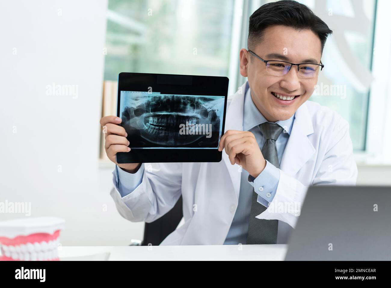 The dentist in dental clinic shows xrays Stock Photo Alamy