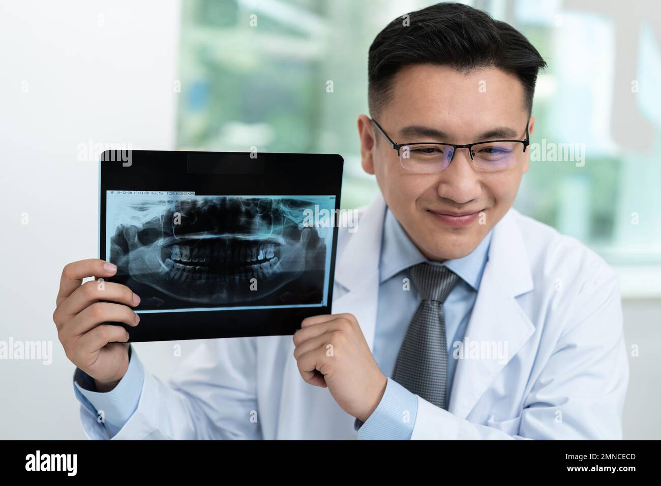 The dentist in dental clinic shows xrays Stock Photo Alamy